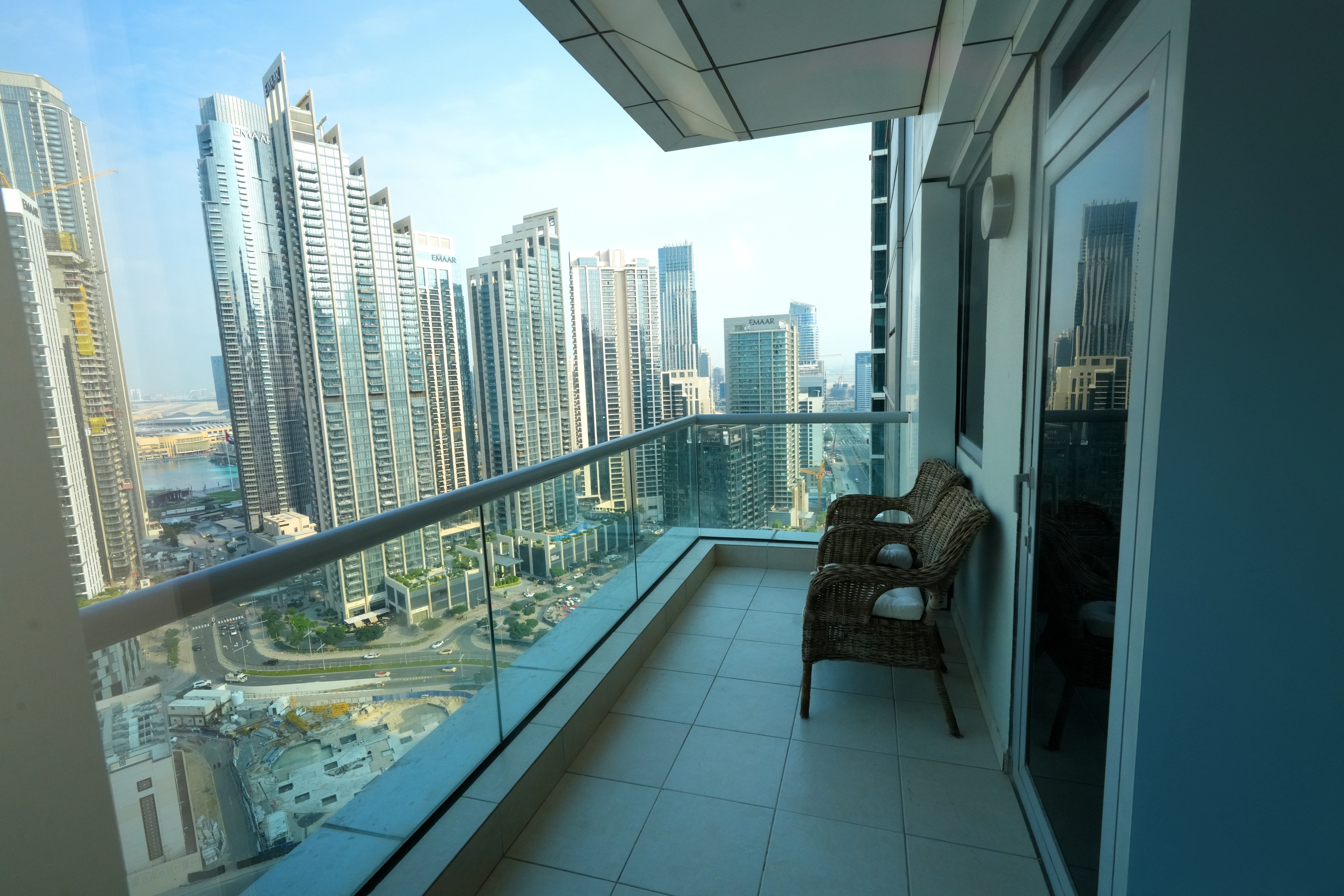 Two table top glass jars of succulents.