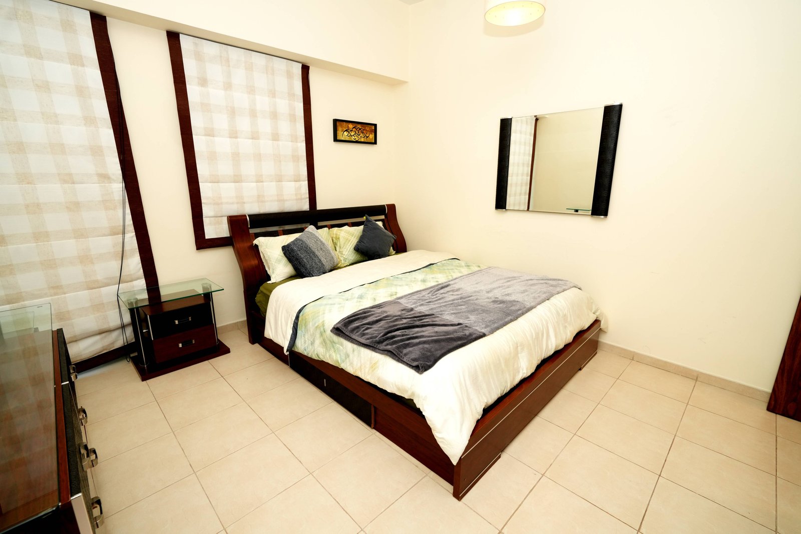 Two table top glass jars of succulents.